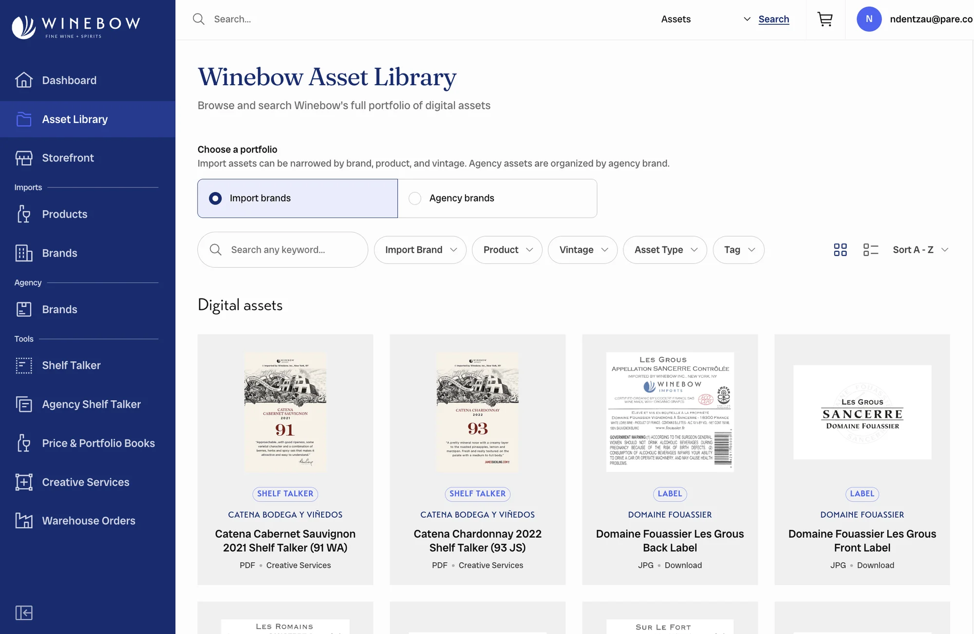 The Winebow Asset Library in Trade Tools: a navy sidebar with Dashboard, Asset Library, Storefront, Products, Brands, Shelf Talker, Price and Portfolio Books, Creative Services, and Warehouse Orders; a portfolio toggle between import and agency brands; keyword search with brand, product, vintage, asset type, and tag filters; and a grid of digital assets such as shelf talkers and bottle labels